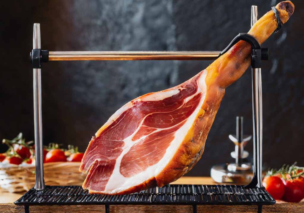 Firefly a fresh iberian ham on a carving rack 7105